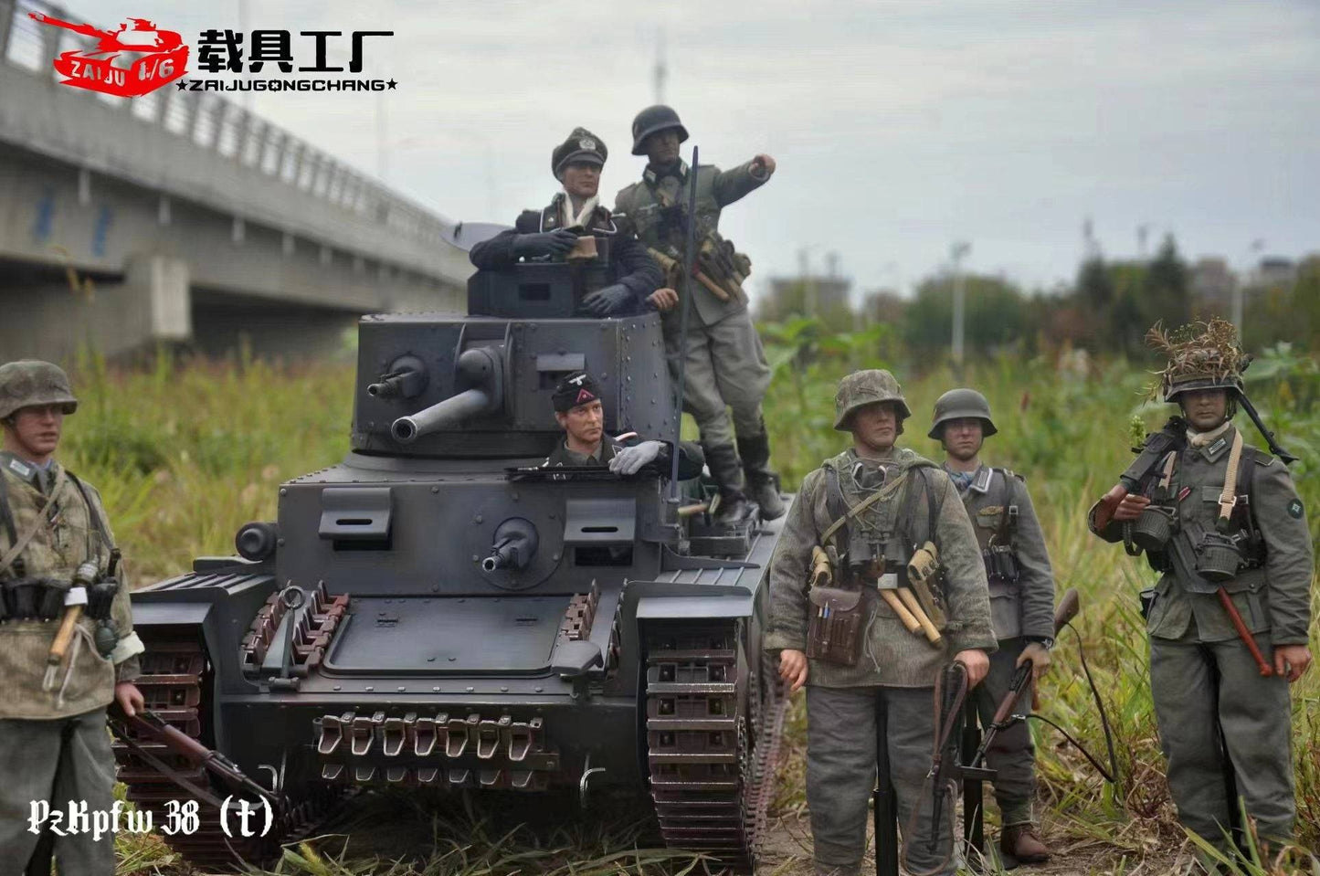 Six military model enthusiasts in WWII-era uniforms gather around a meticulously crafted eaxtoys 1/6 scale Panzerkampfwagen 38(t) model on the grass. A soldier stands atop, pointing forward, with a bridge in the background, enhancing their historical homage.