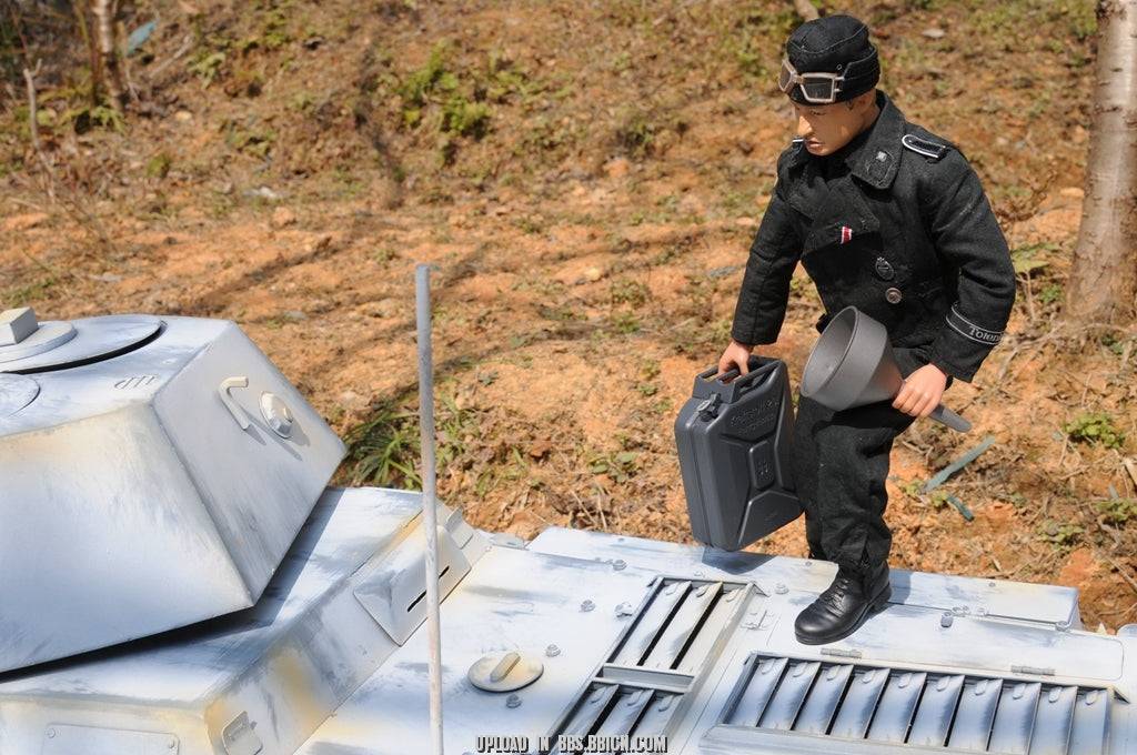Miniature soldier carrying a fuel canister on top of the EAXTOYS 1/6 scale WWII German Sd.Kfz.234/2 Puma model.