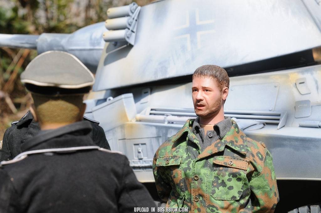 Miniature soldier in camouflage uniform engaged in a discussion near the EAXTOYS 1/6 scale WWII German Sd.Kfz.234/2 Puma model.