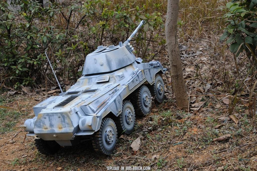 EAXTOYS 1/6 scale WWII German Sd.Kfz.234/2 Puma model positioned near a tree, showcasing its rugged and realistic design.